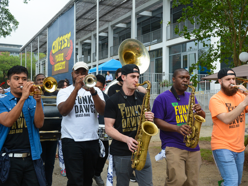 Brass band parades across uptown campus during Crawfest
